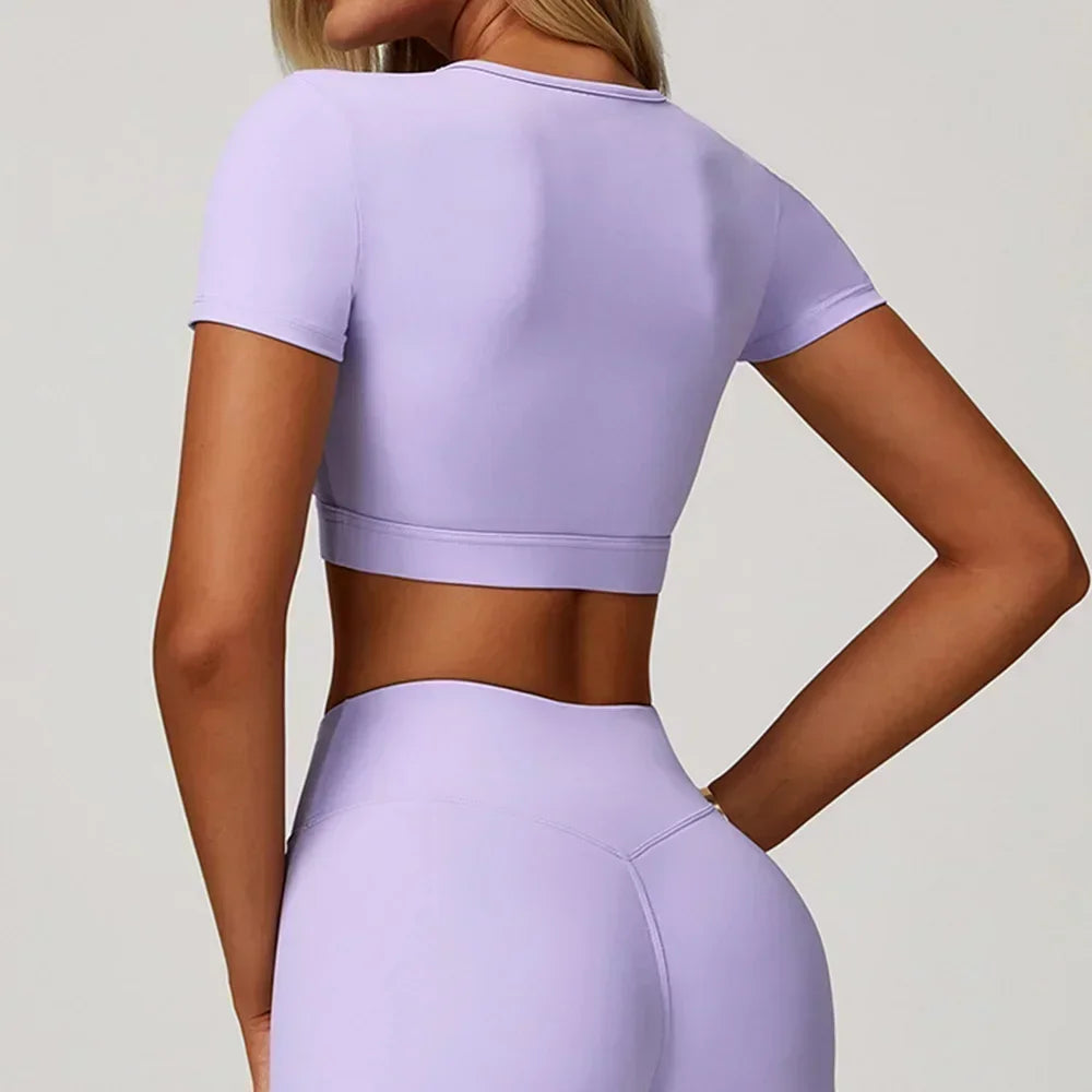 Person wearing a lavender athletic outfit on a plain background