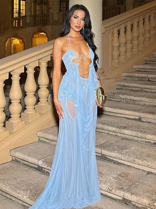 Woman in a light blue evening gown standing on a staircase