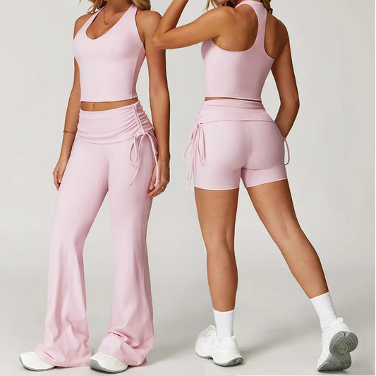 Two women wearing pink athletic outfits on a plain background