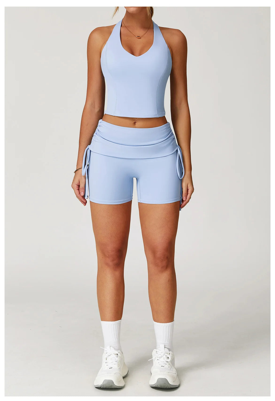 Person wearing a light blue athletic outfit on a white background